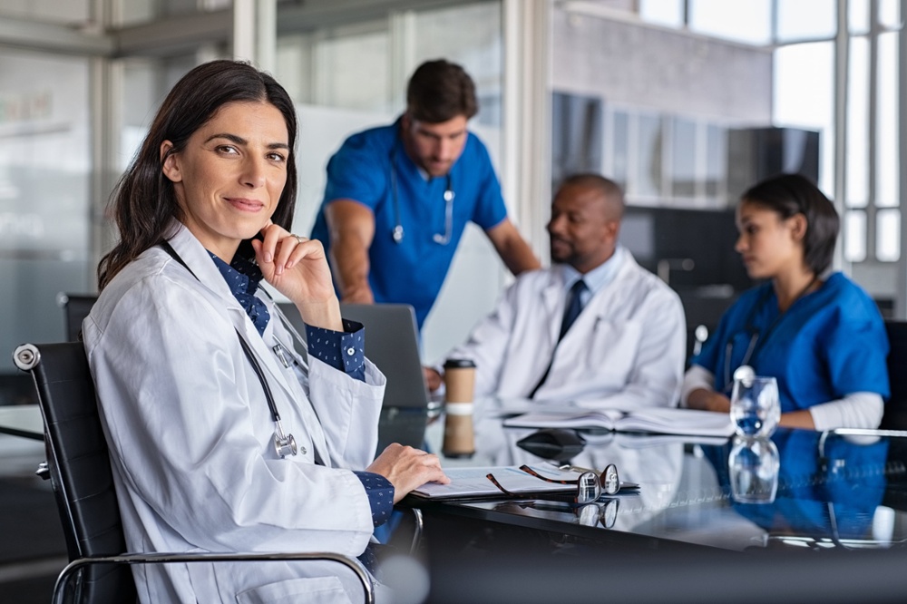 Nursing professional in a white coat.